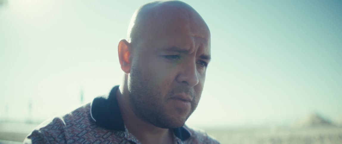 The man thinks while looking at his computer outside
