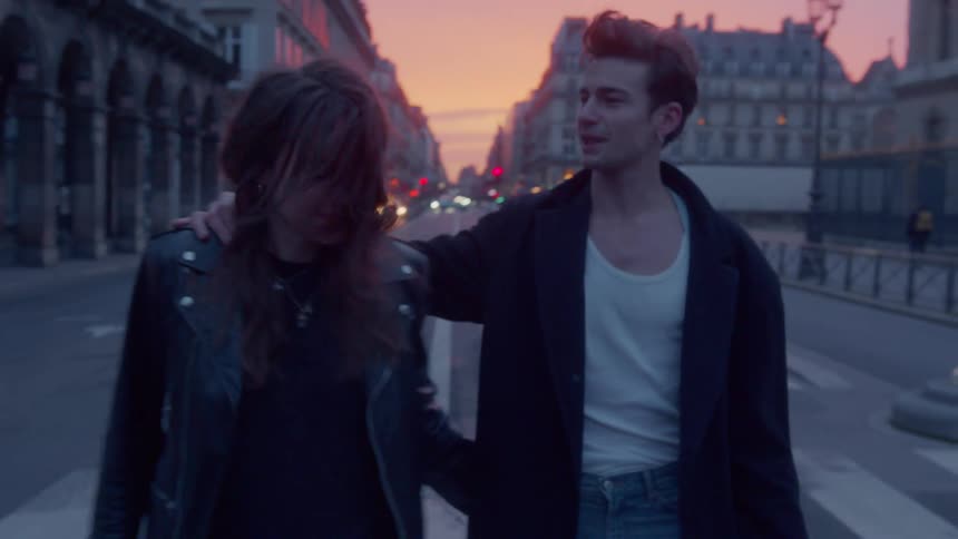 A man and woman walking together at sunset
