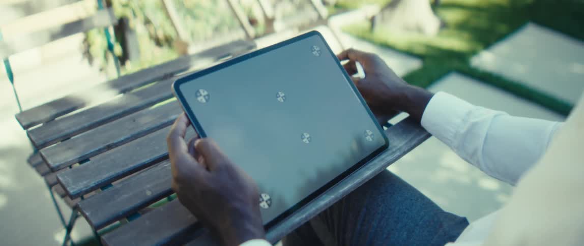 A man using a tablet outdoors