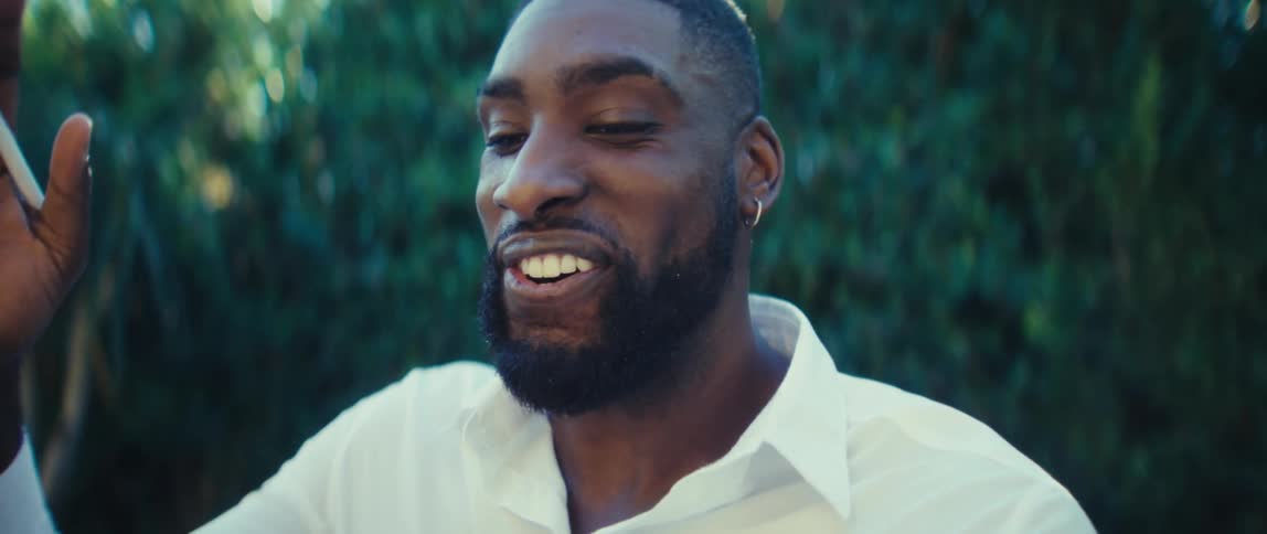The man smiles while on a video call with his tablet