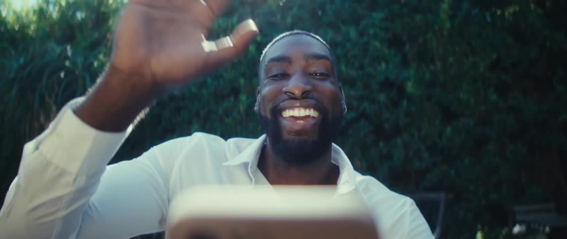 Man making a hand gesture during a smartphone video call