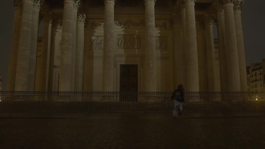 Couple running through the city streets at night