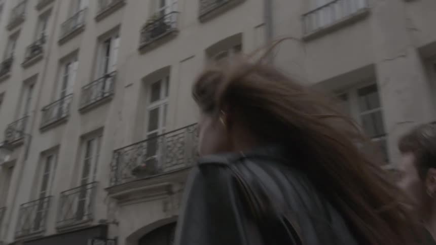 The man walks with his arm around a womans shoulders