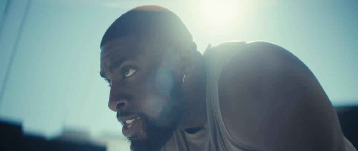 Man in a tank top with a determined expression