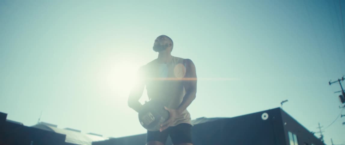 Man throwing a basketball under the sunlight