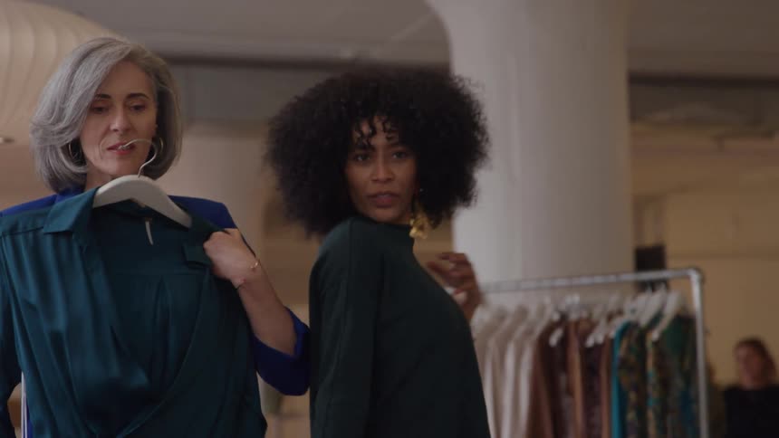 A couple women trying on clothes