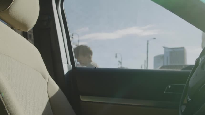 A teenage boy exits his car and then realizes he locked the keys inside