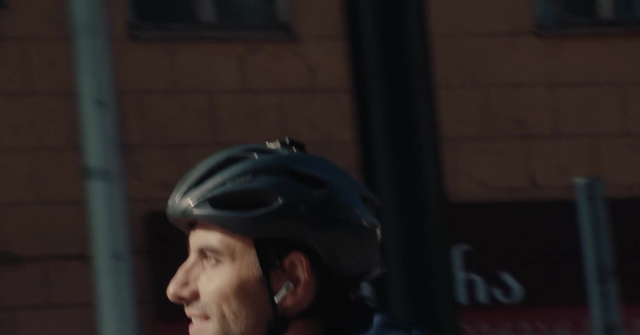 Cyclist rides on a busy avenue during the day