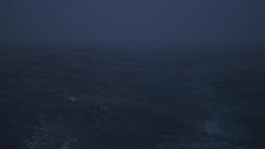 An ocean view with fog covering the atmosphere and light waves moving the water