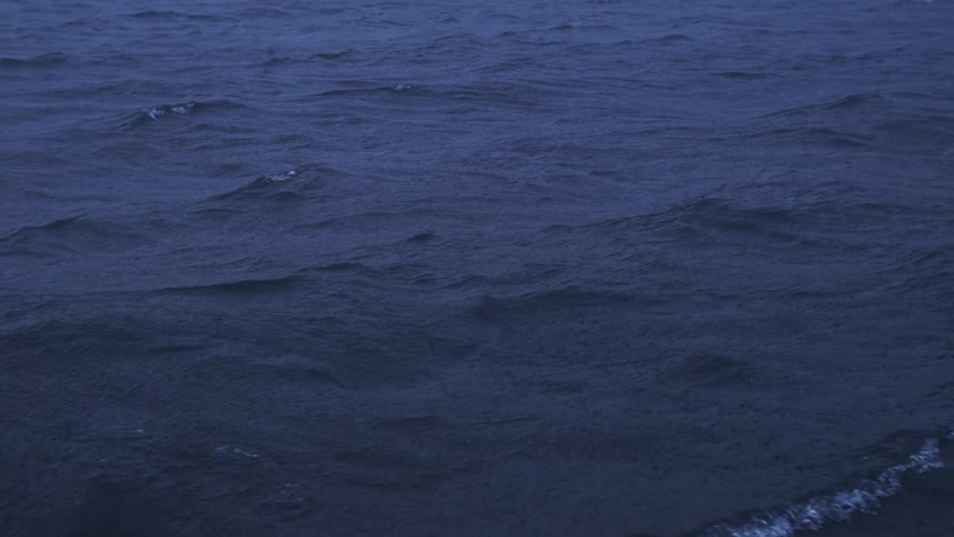 An ocean view with the water moving due to light waves at midday