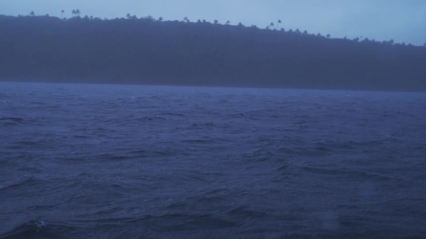 Rain falls on the river as it moves along the coast