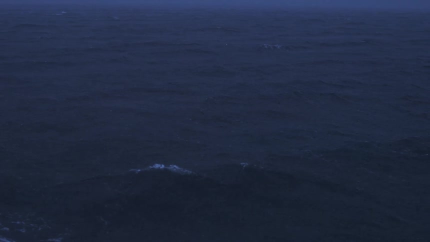 Dark sea with small waves under dim evening light