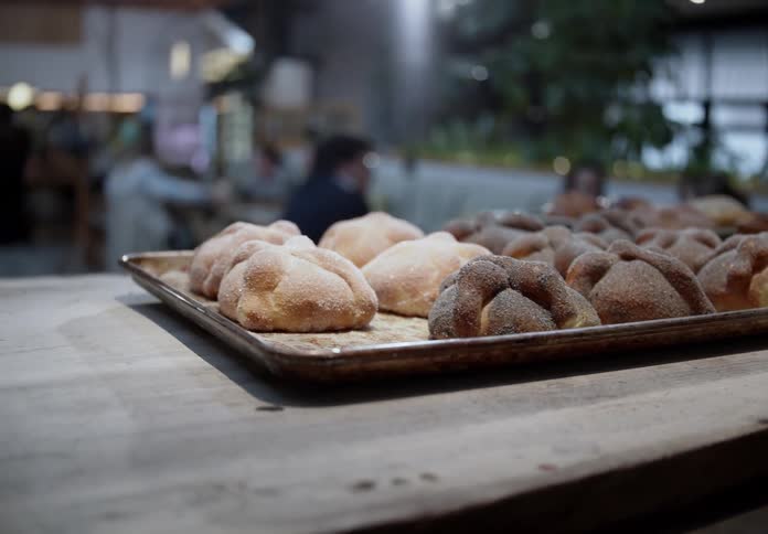 Freshly baked artisanal breads arranged on a baking tray over the counter