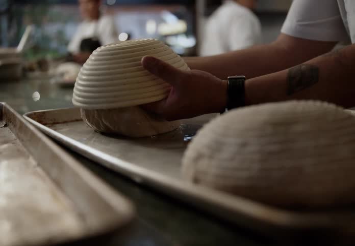 The cook is making bread in the restaurant