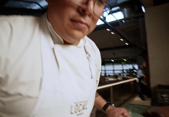 The man bakes bread in the restaurant