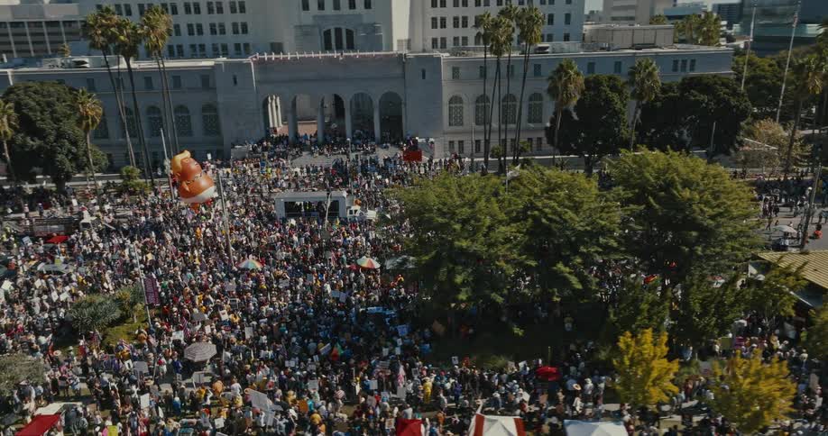 Crowd gathered in front of a public building during an outdoor event