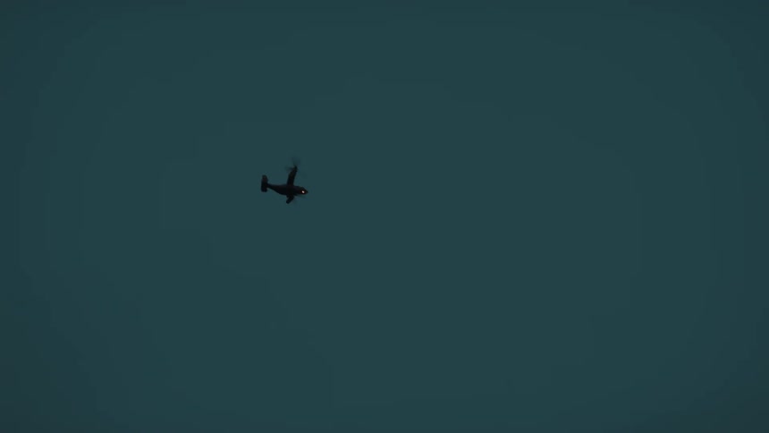 Helicopter crosses the dark sky with its lights on
