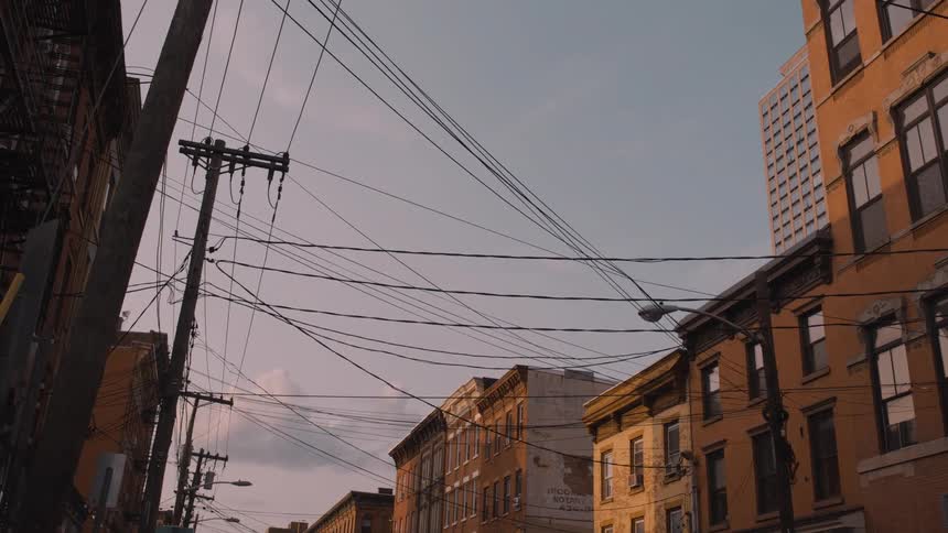 Power lines stretch between buildings