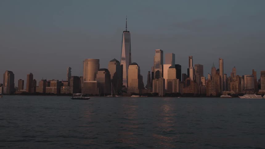 City skyline reflecting the golden sunset light over the river