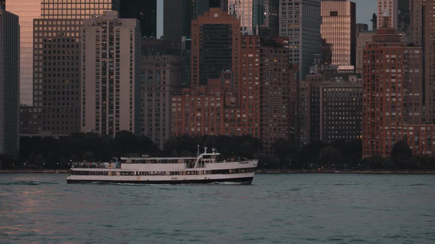 The ferry transports people past the city