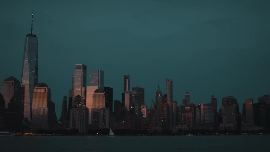 City lights begin to glow as dusk settles over the skyscrapers
