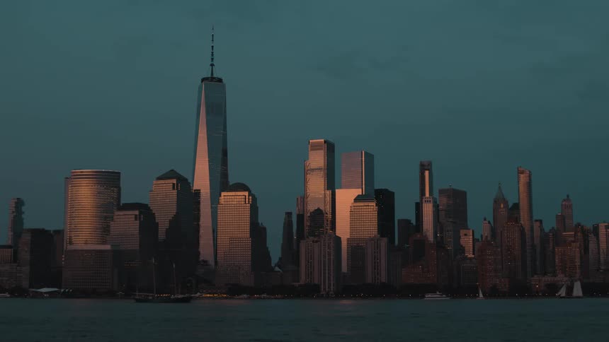Modern towers and skyscrapers on the metropolitan coast as boats sail on the water