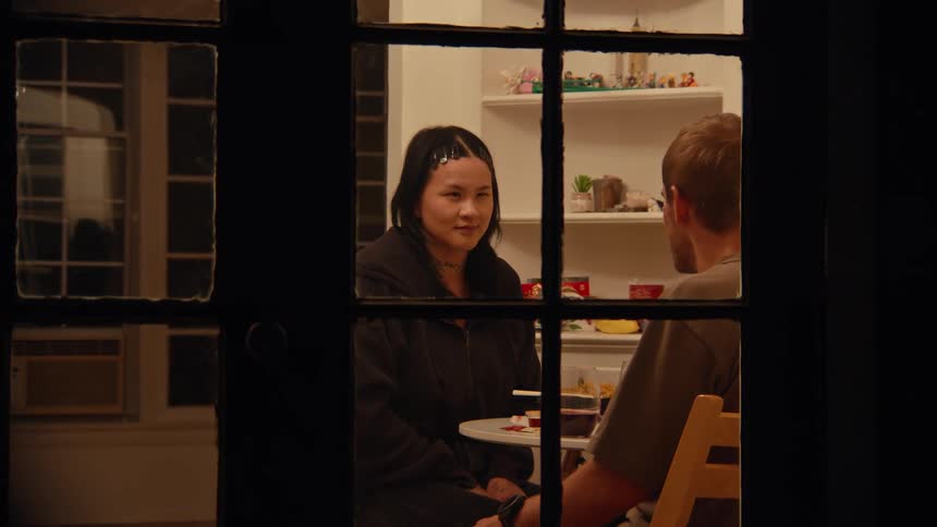 Two people sitting in a kitchen talking