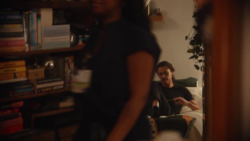 A woman getting dressed and then hugging a man before leaving