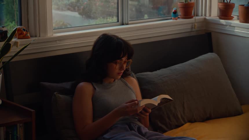 A woman reading a book in bed
