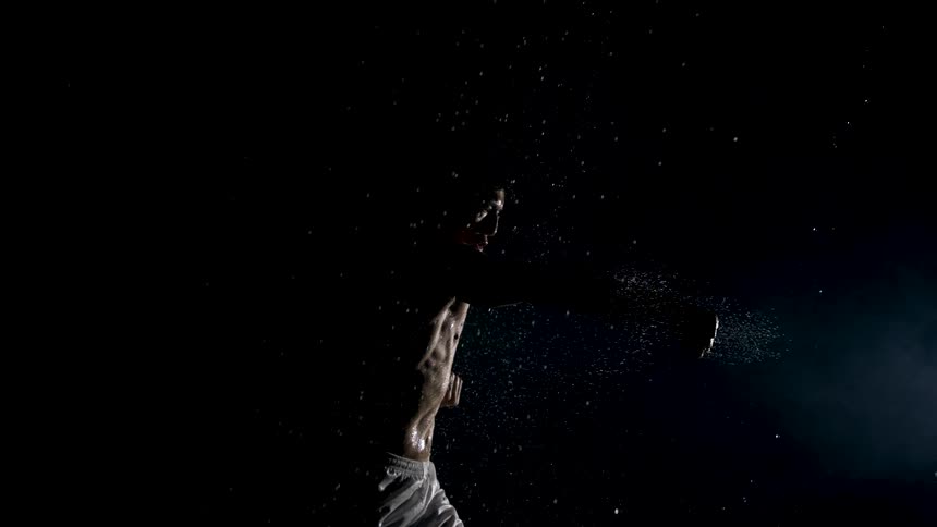 Fighter trains intensely under rain and dim lights