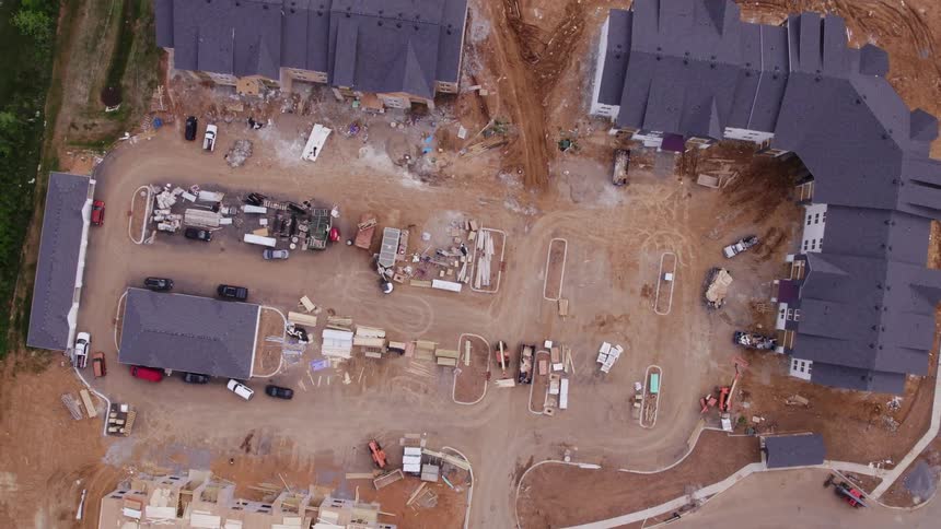 Aerial view of a truck moving supplies at a neighborhood construction site