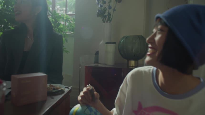 Women talk and smile at home