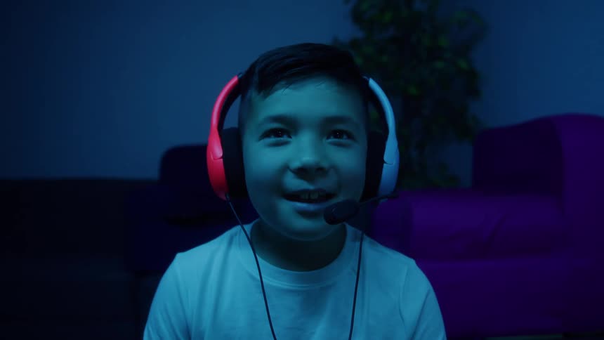 The boy is having fun playing video games