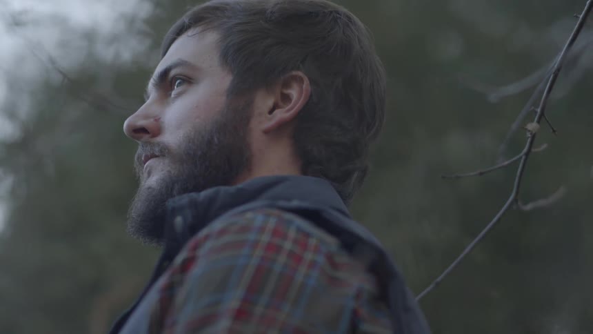 Man standing in the woods looking