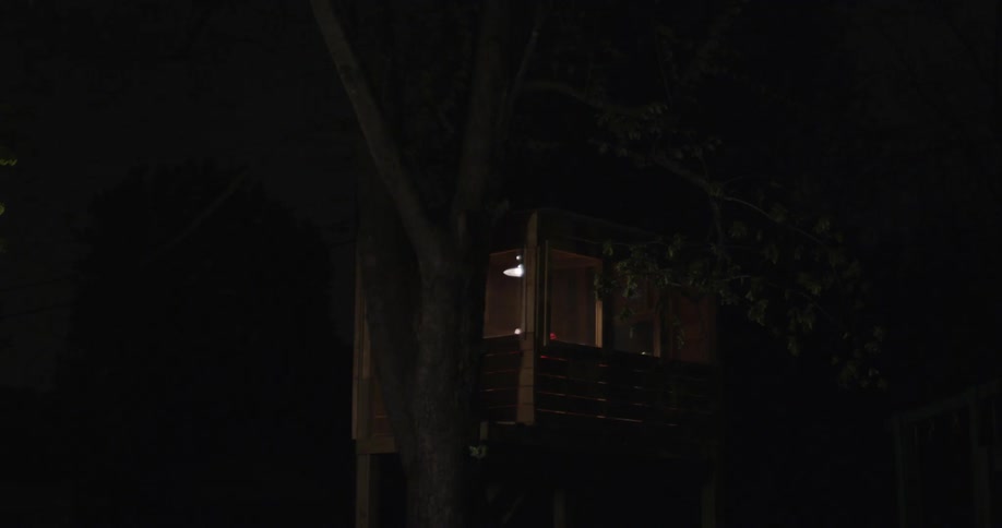 Person spinning around in the distance in a dimly lit area indoors