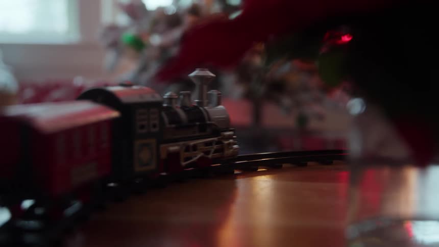 A toy train follows the tracks