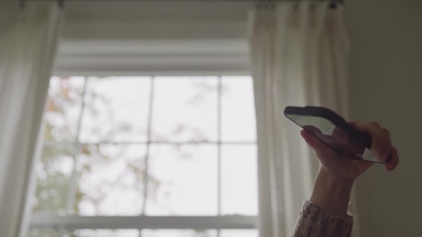 Girl holding her phone up in the air