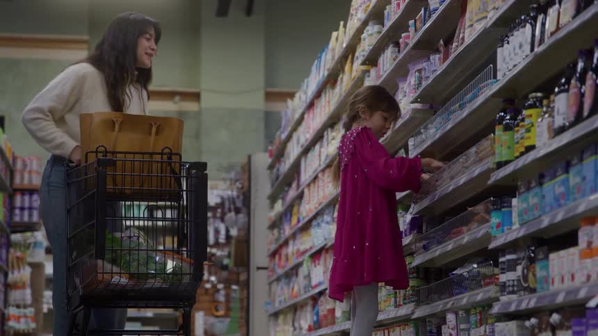 Mother and daughter are shopping in the grocery store