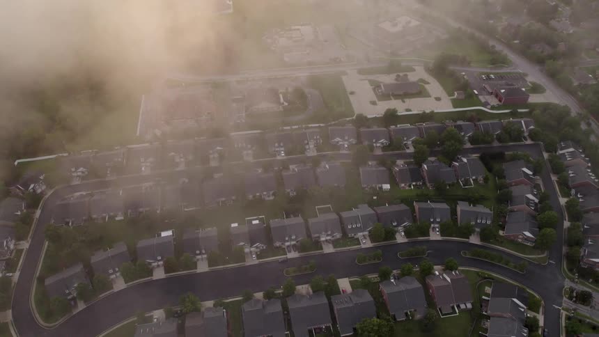 Morning fog covers part of the neighborhood from above
