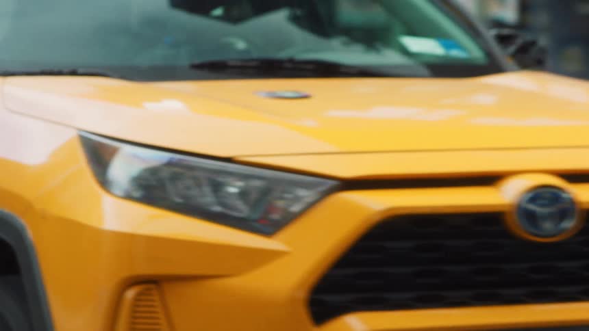 A taxi driving down a road