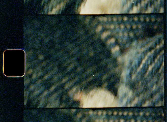 A close up shot of a vintage denim zipper showing its worn teeth and fabric texture