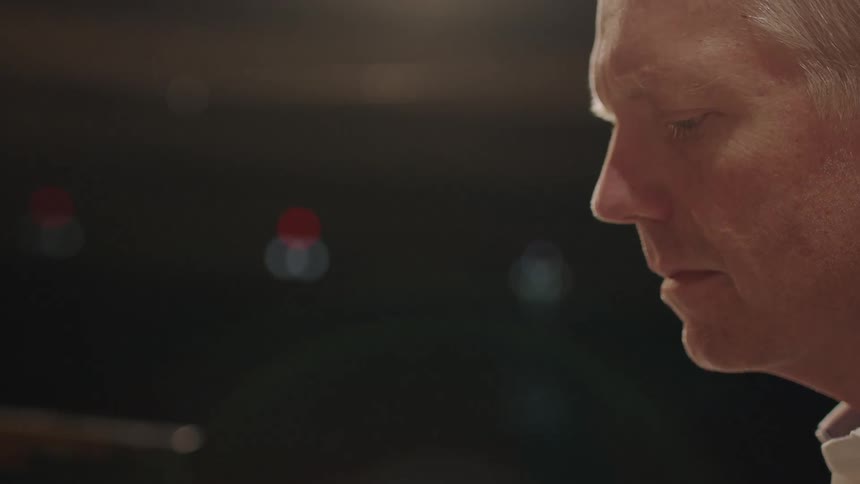 A man looks down on stage
