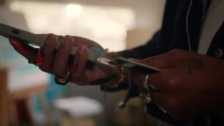A person holding a device and then swiping a credit card underneath