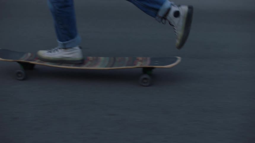Teenager riding a skateboard on a neighborhood street