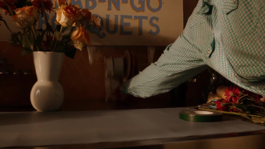 A person grabbing ribbon from a roll