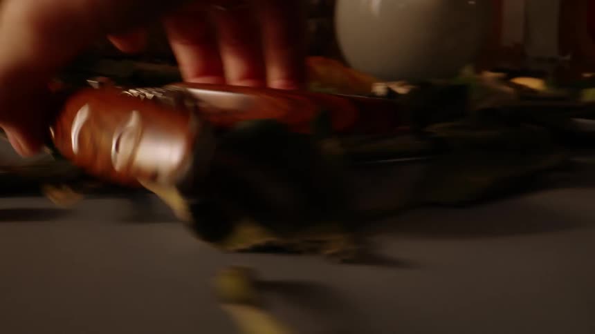 Hands pick up tools from a table with flower branches