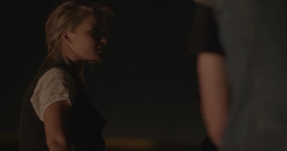 Girl talking to another person outside in the dark night