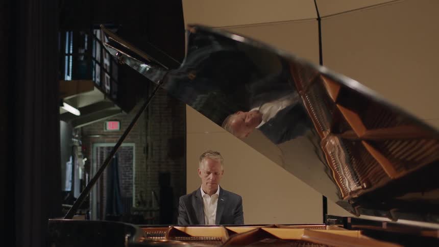 A man is playing the piano