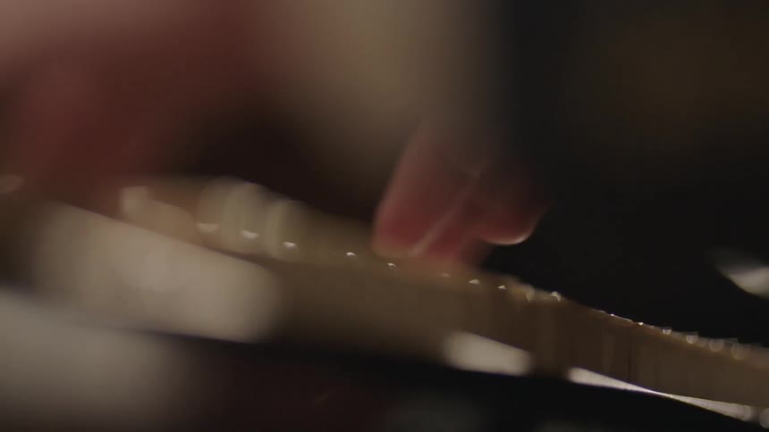 Fingers press down on the keys of a piano