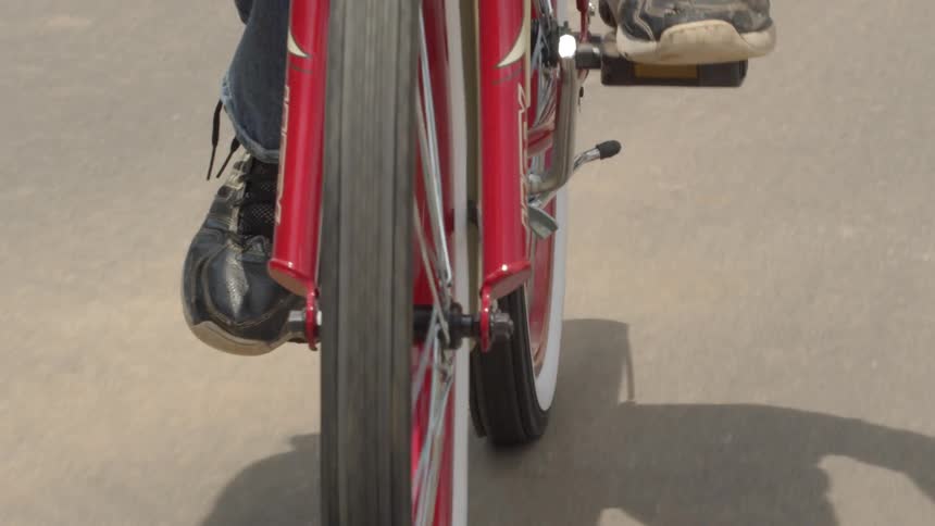 Person is riding and pedaling a bicycle